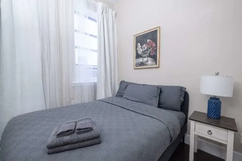 Cozy gray bed with nightstand