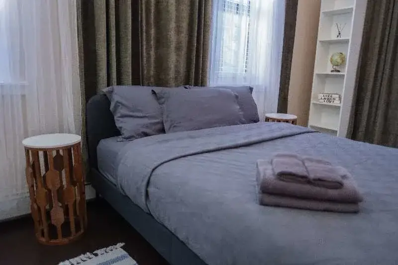 Cozy gray bed, folded towels