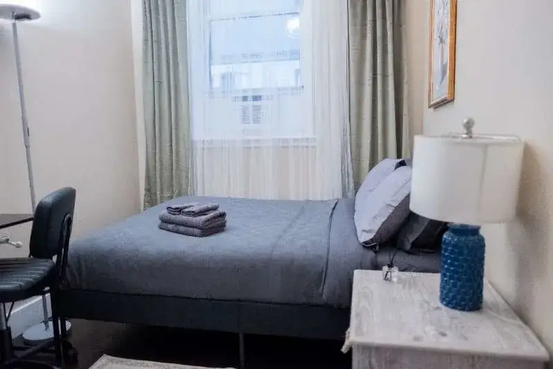 Cozy gray bedroom with lamp