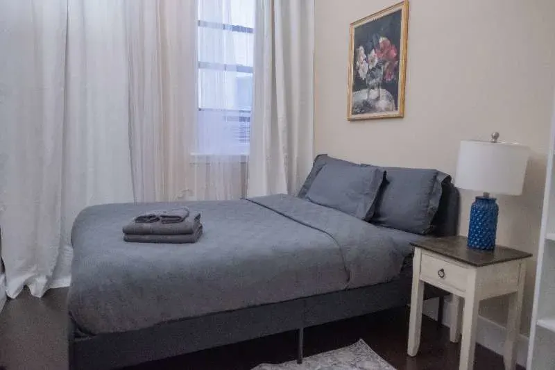 Cozy bedroom, gray bedding, lamp