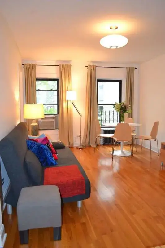 Sunlit living room with dining