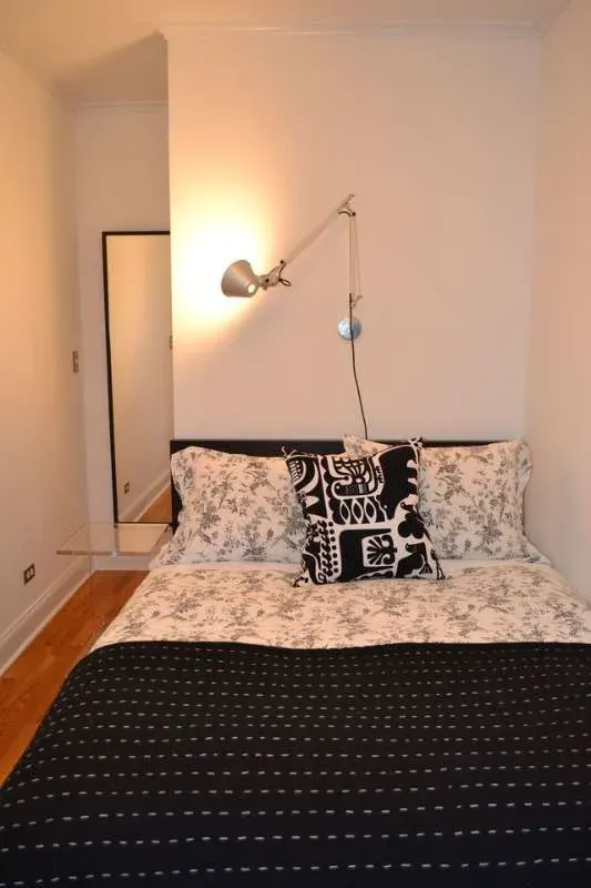 Compact bedroom featuring patterned bedding