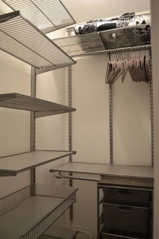 Empty, organized walk-in closet shelves