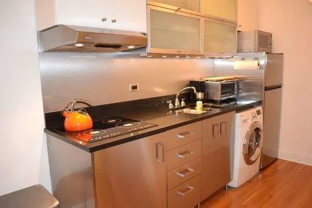 Compact modern kitchen, orange kettle