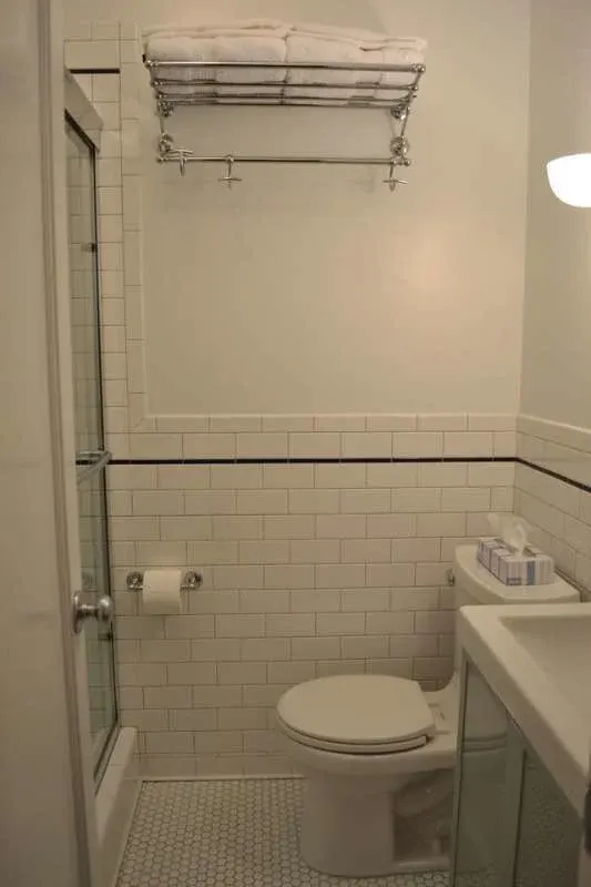 Small white bathroom with towels
