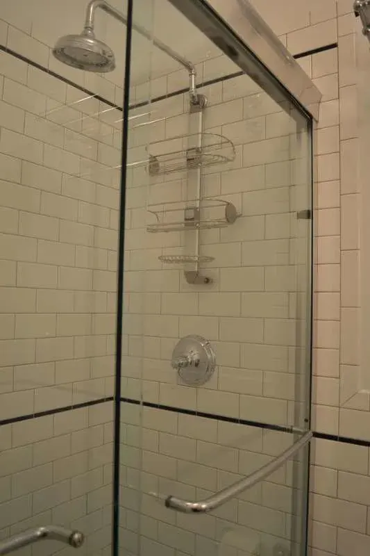 Glass-enclosed shower with subway tiles