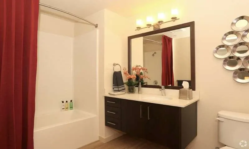 Contemporary bathroom with red curtain
