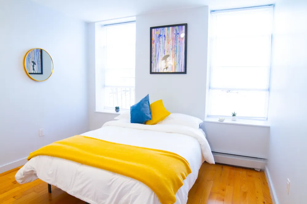 Bright cozy bedroom with colorful accents.