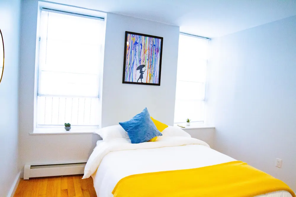 Bright, cozy bedroom with colorful decor.