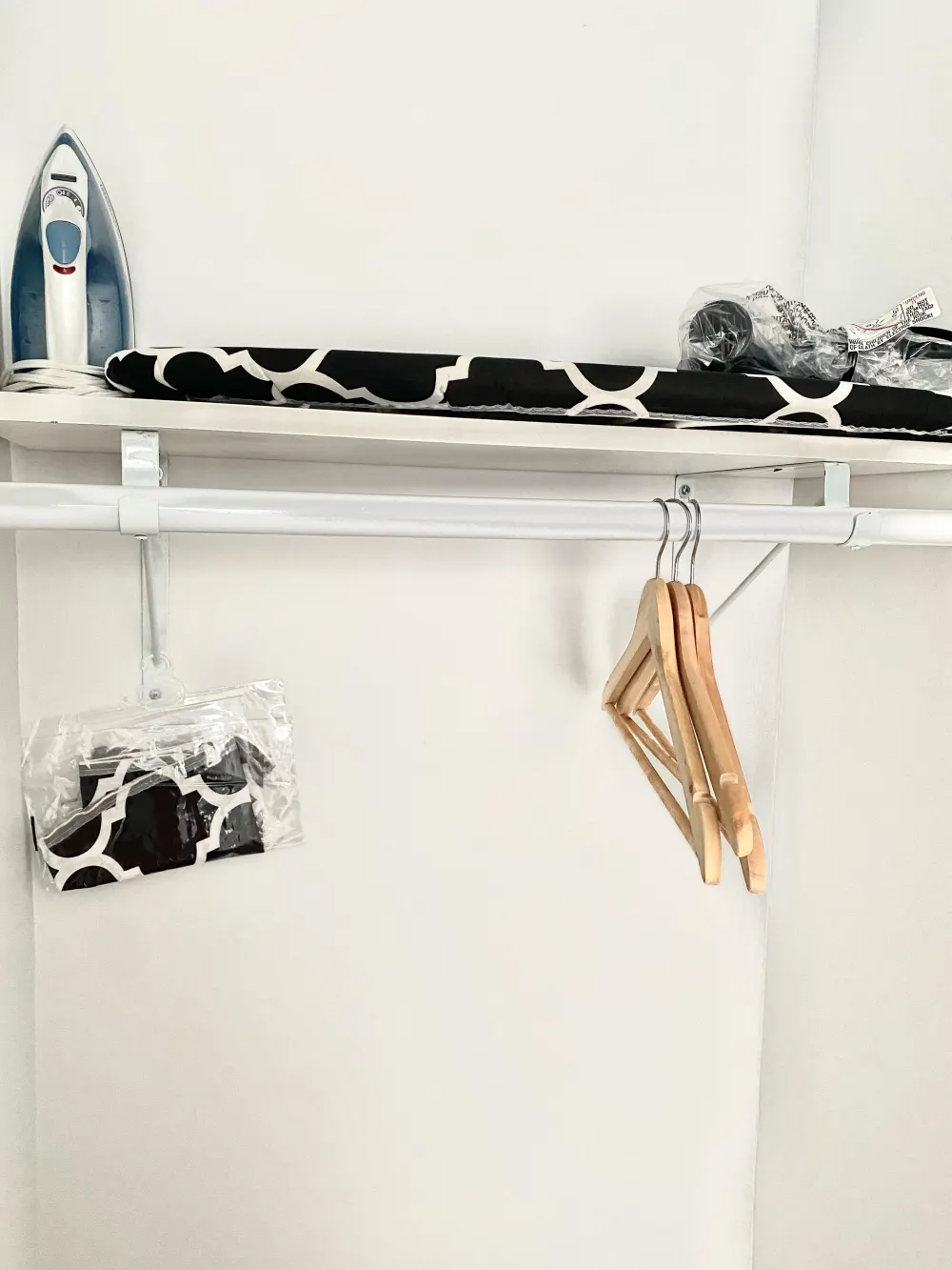 Closet essentials: iron, hangers, ironing board.