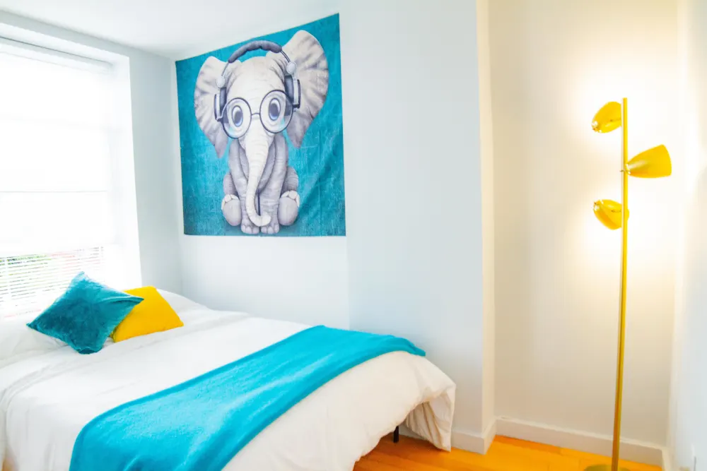 Bright bedroom with quirky elephant decor.