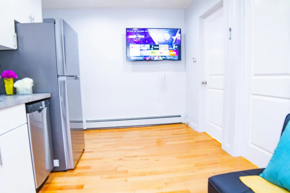 Modern kitchen with mounted TV.