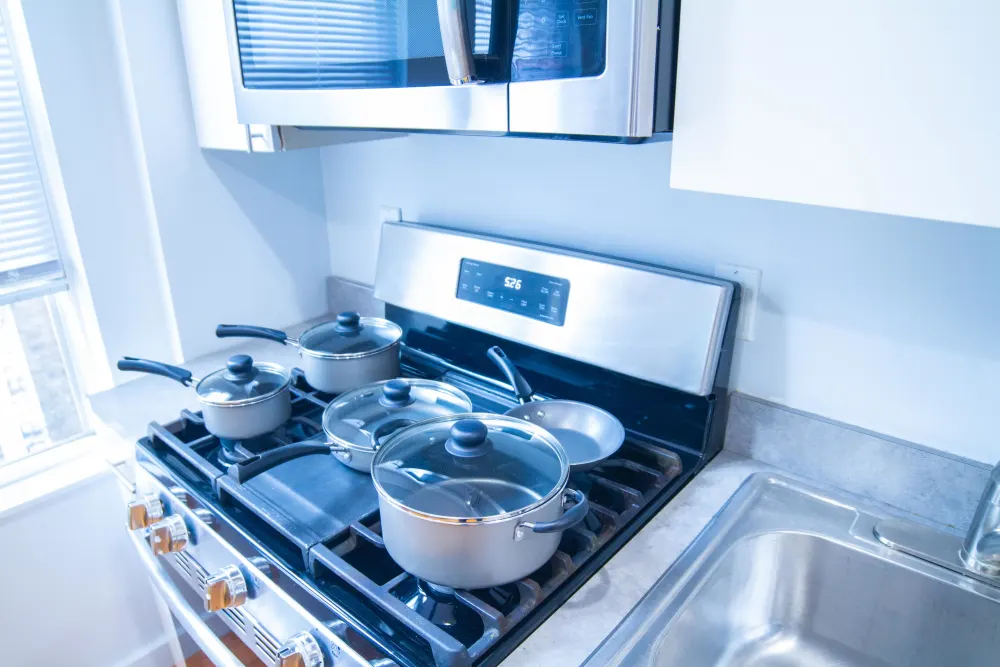 Modern kitchen with pots, pans.