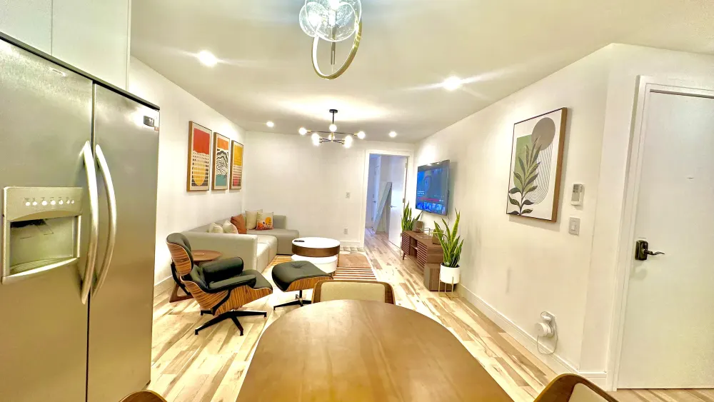 Modern, cozy living room with kitchen.