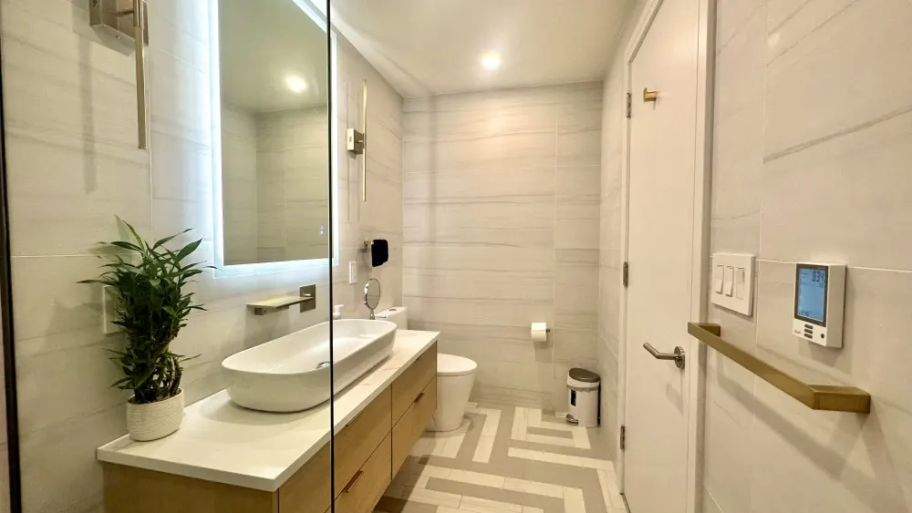 Modern, elegantly lit bathroom interior.