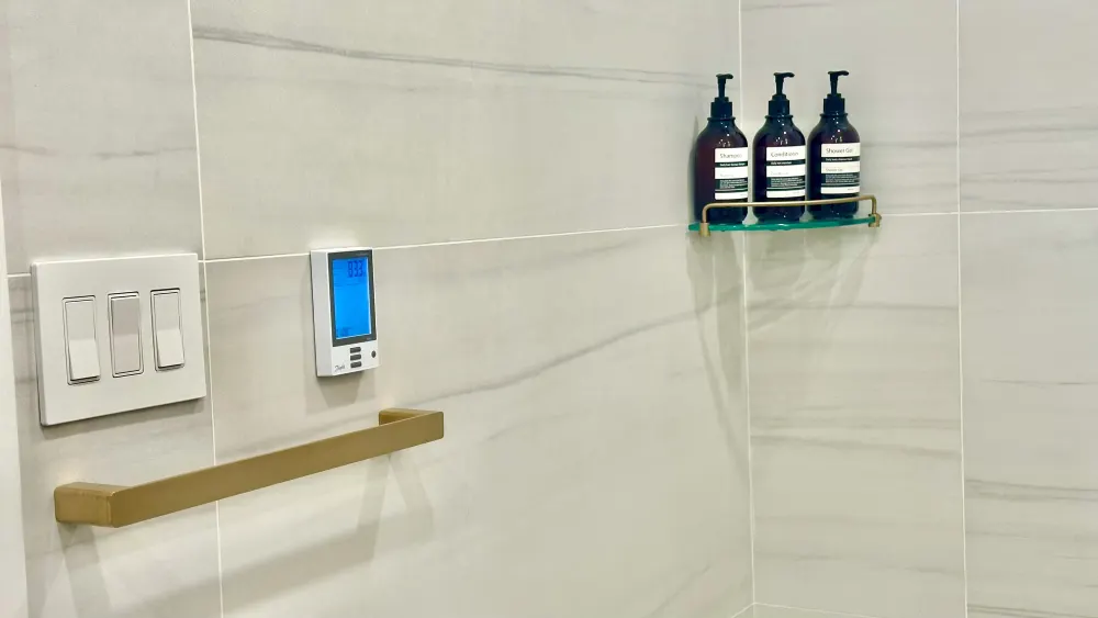 Modern bathroom with toiletry dispensers.