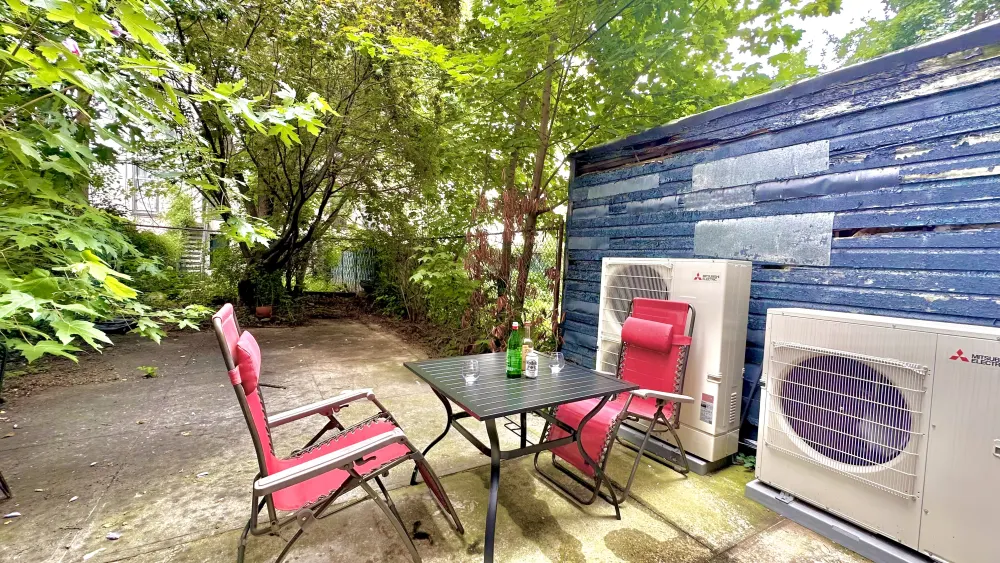 Cozy backyard patio with greenery.