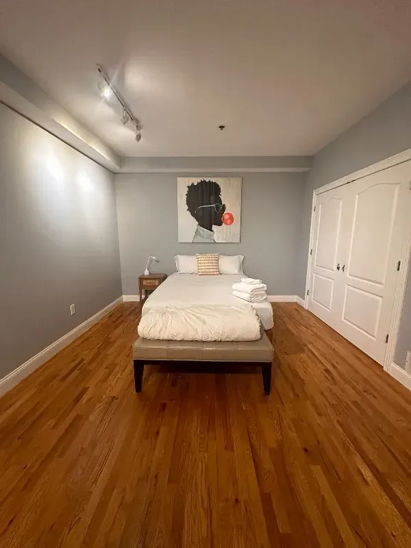 Minimal bedroom, artwork above bed