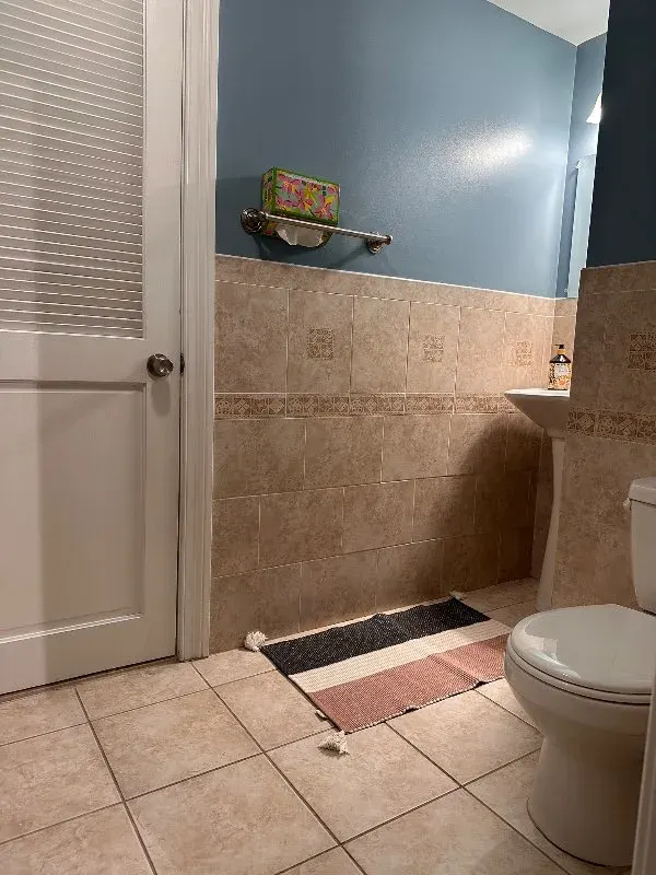 Tiled bathroom with blue walls
