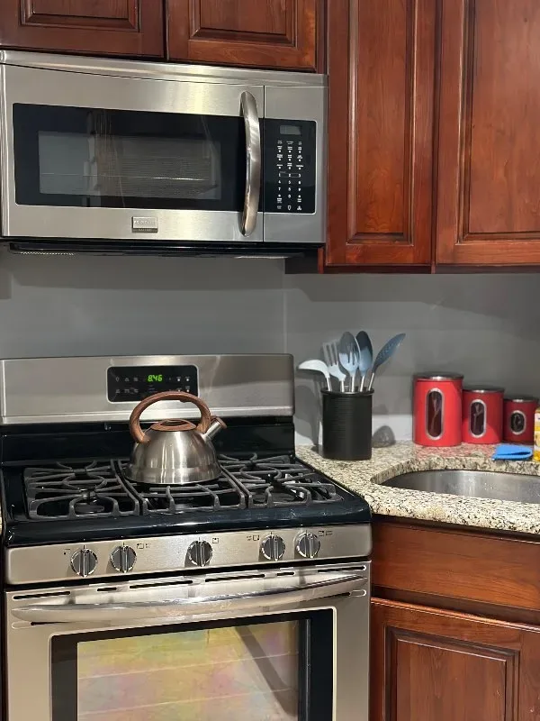 Stainless stove with kettle, cabinets