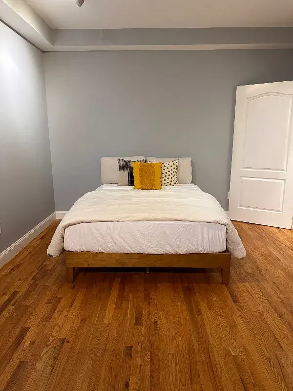 Minimal bedroom, yellow accent pillow