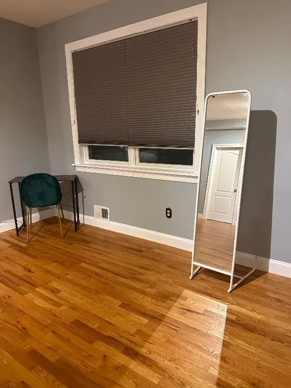Sparse room: mirror, desk, chair