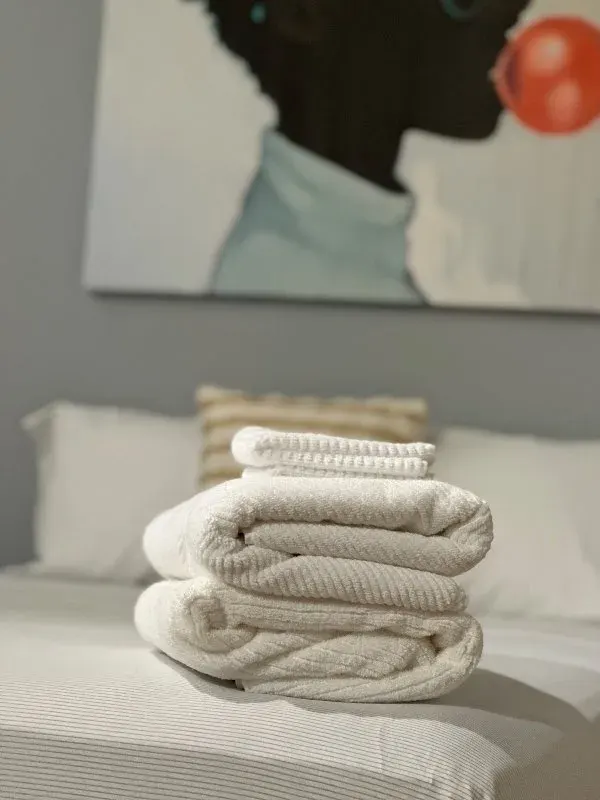 Folded plush towels on bed
