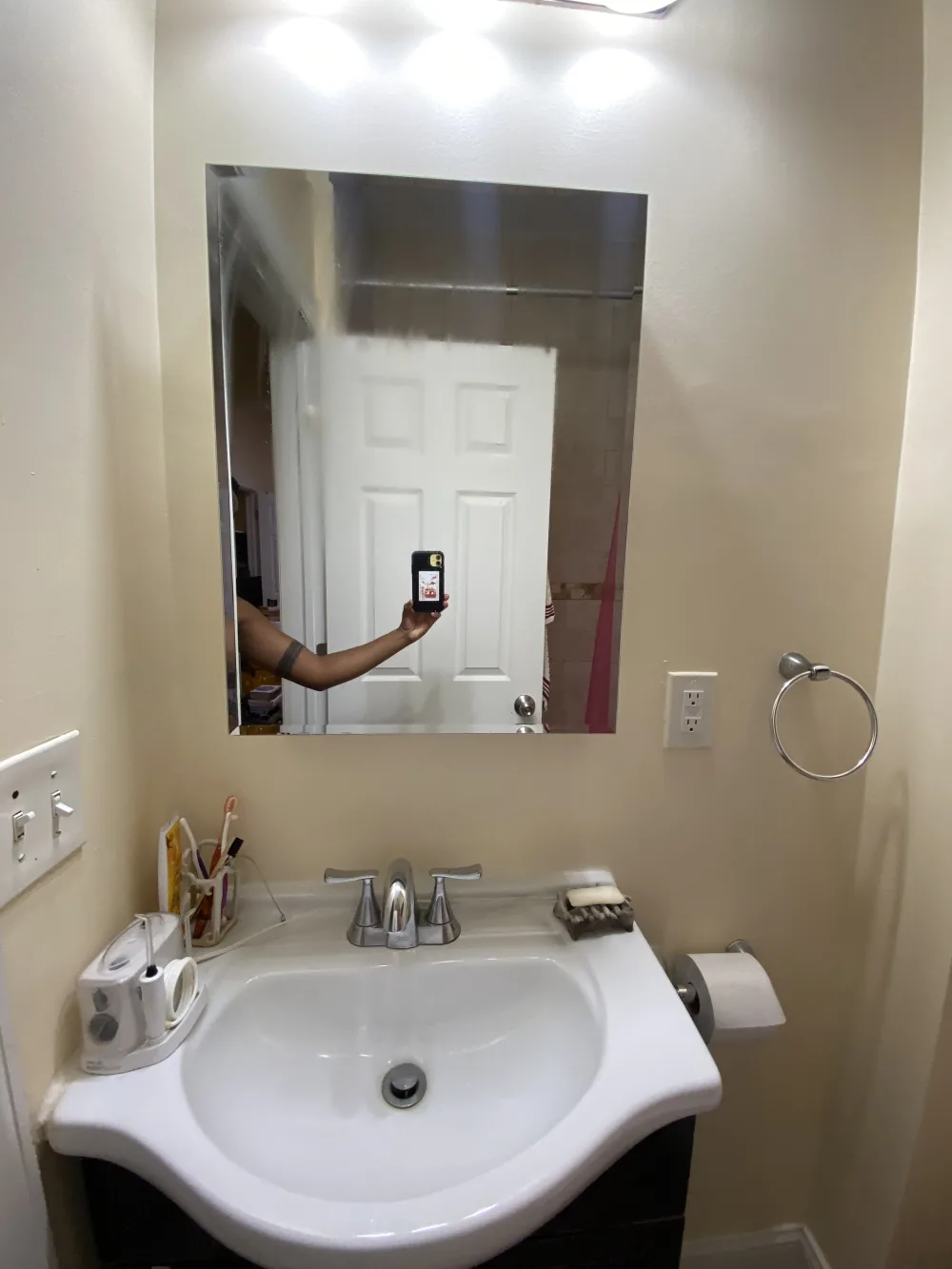 Bathroom sink with mirror reflection.