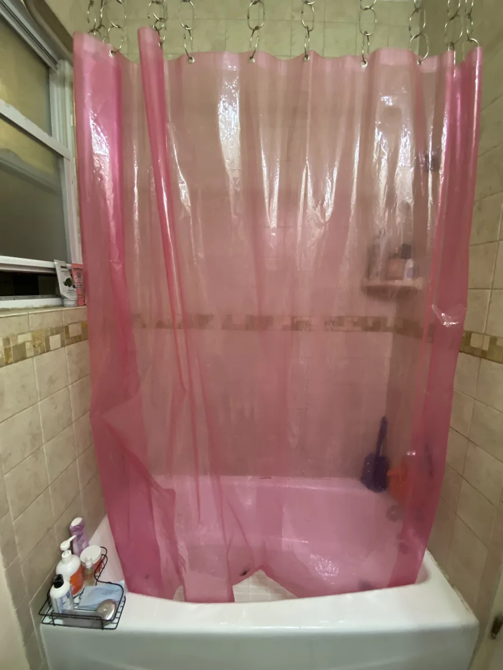 Bathroom with pink shower curtain.