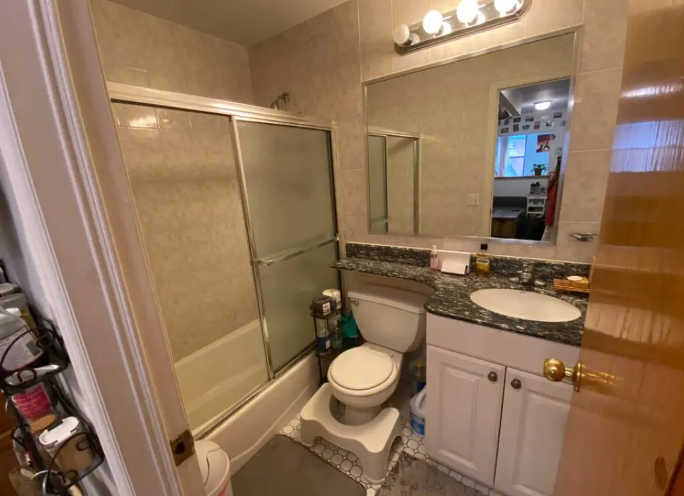 Compact modern bathroom with shower.