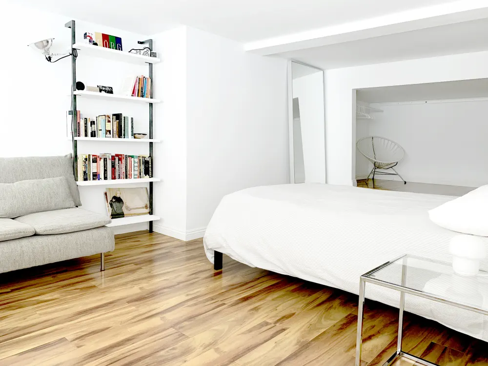Bright modern bedroom with bookshelves.