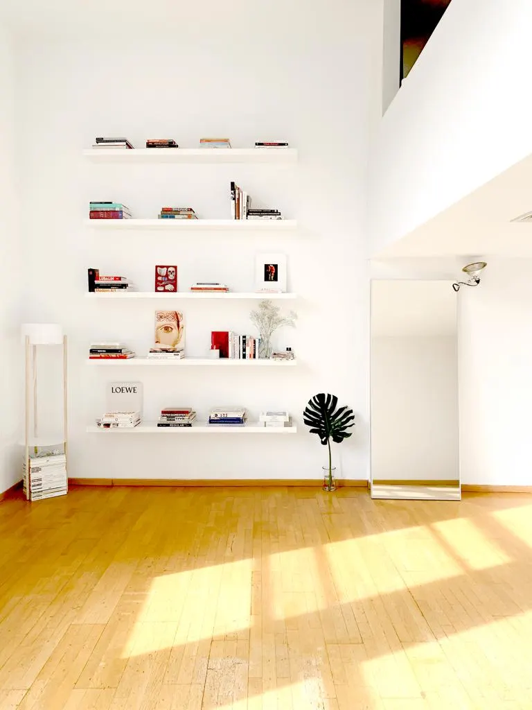 Bright minimalist room with bookshelves.