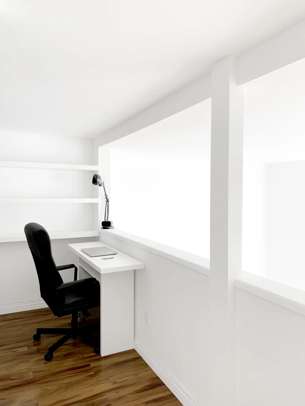 Minimalist white workspace with chair