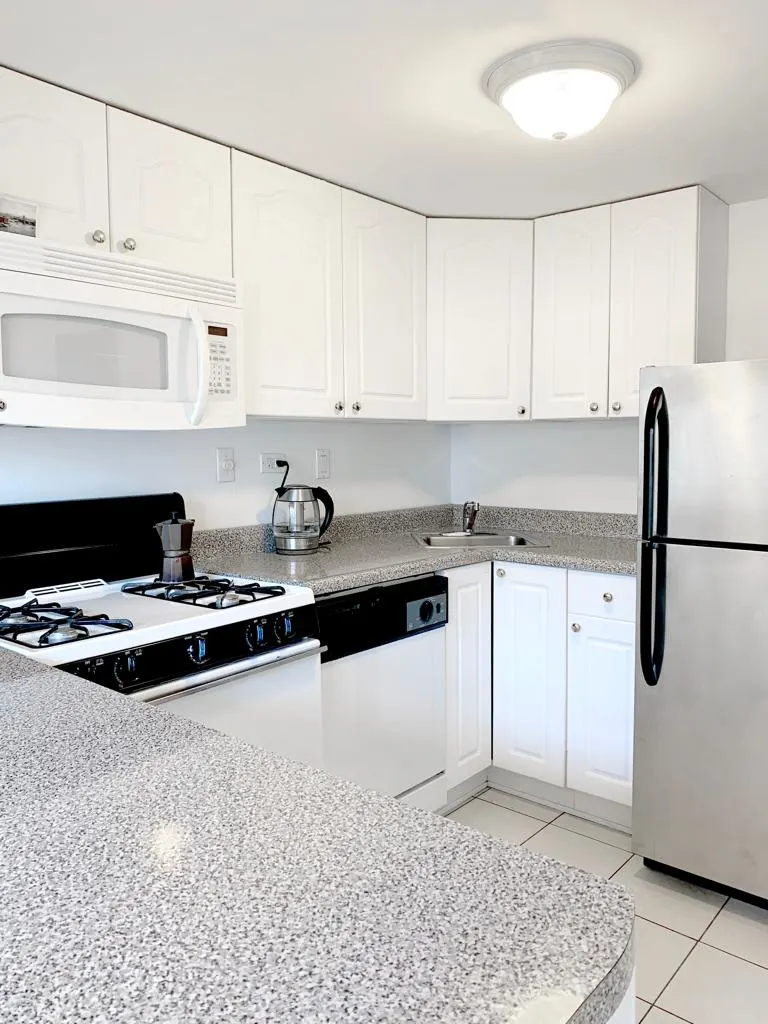 Modern white kitchen with appliances.