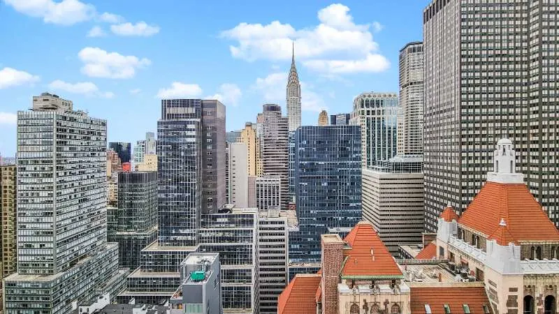 Sunlit urban skyline with spire