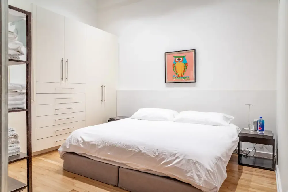 Bright, minimalist bedroom with artwork.