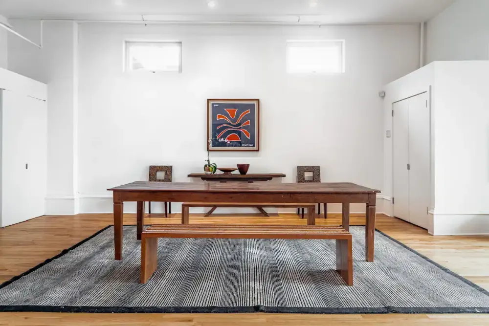 Minimalist dining area with artwork.