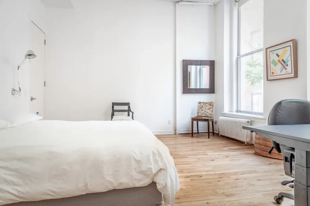 Minimalist bedroom with modern furnishings.