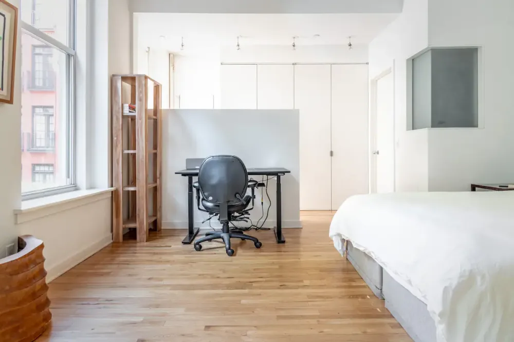 Bright, minimalist bedroom with workspace.