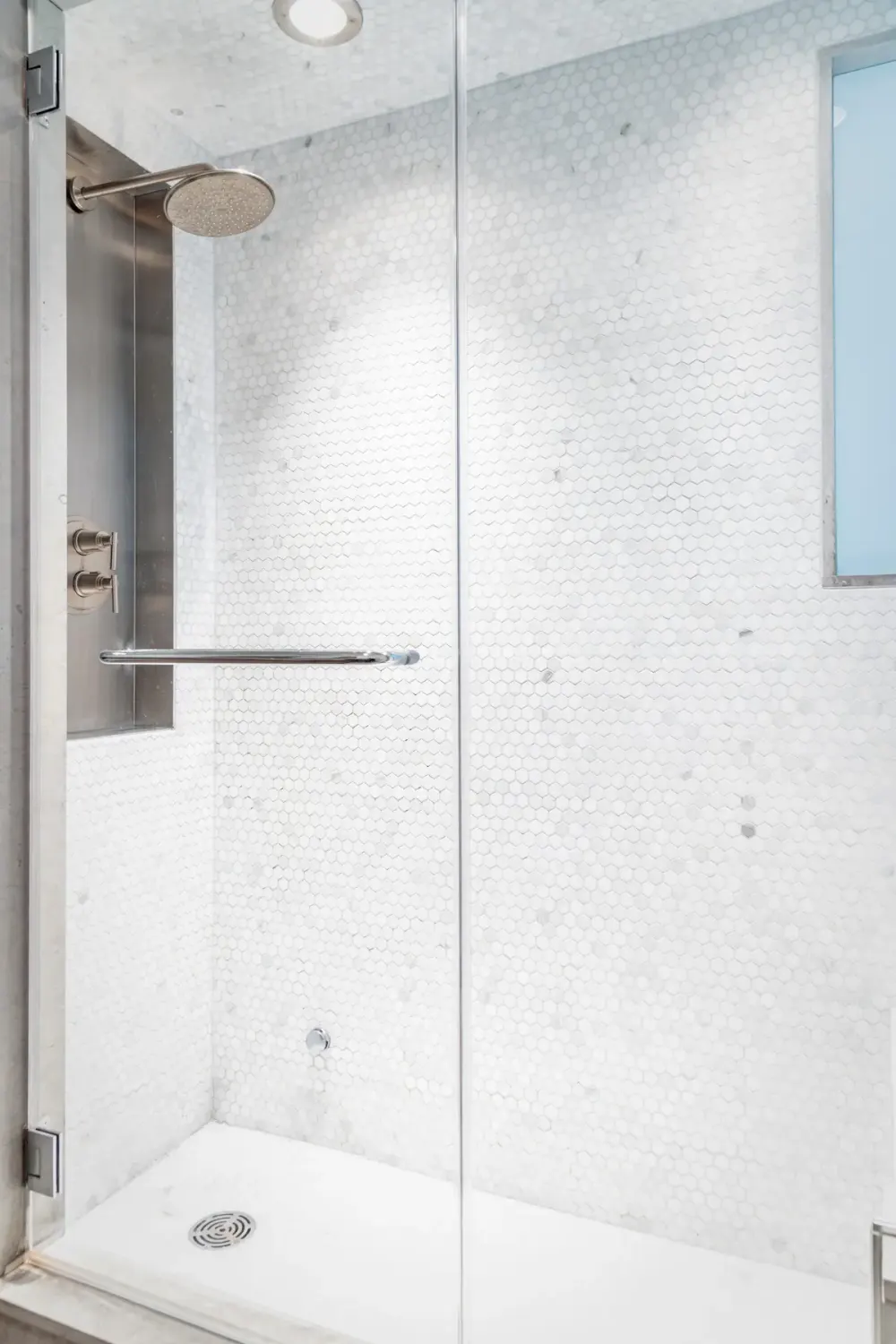Modern white-tiled shower enclosure