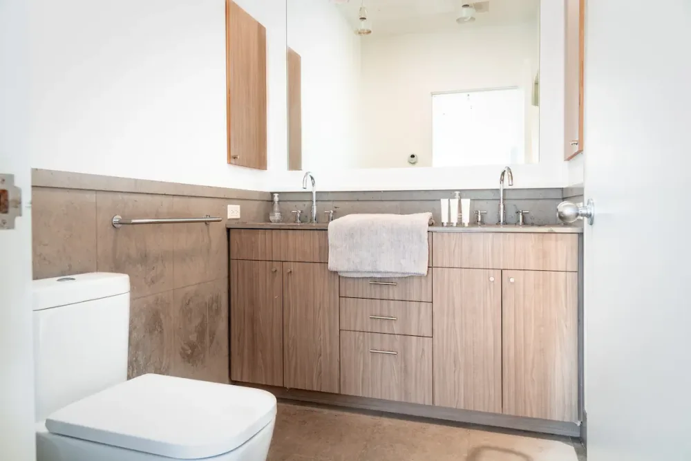 Modern bathroom with wooden cabinets.