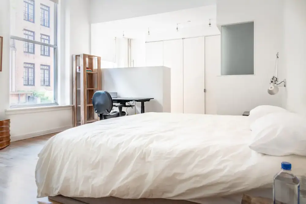 Bright minimalist bedroom with desk.