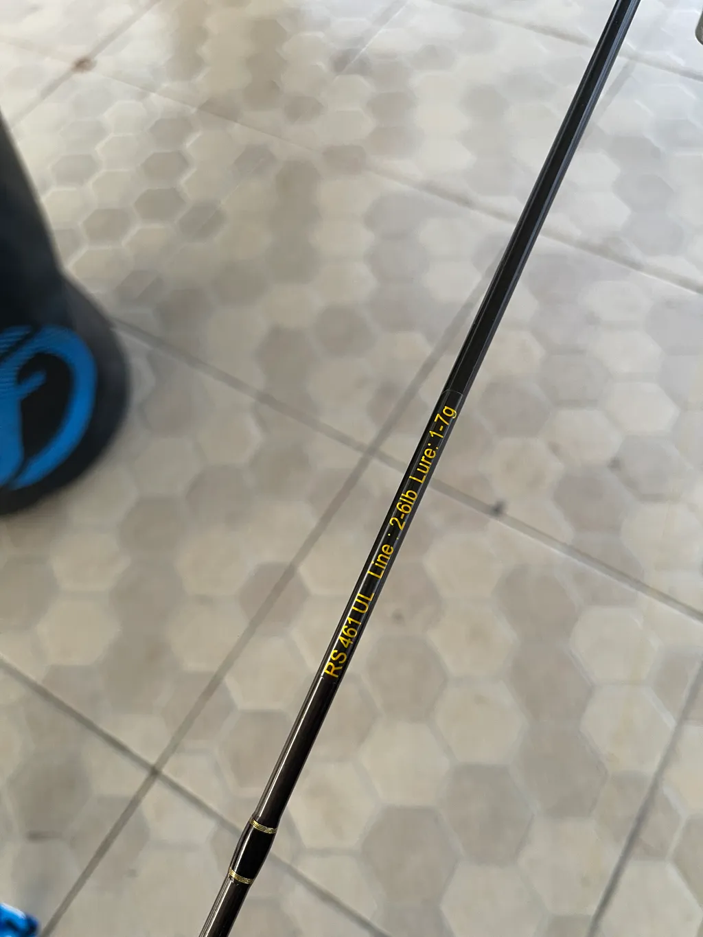 Close-up of a shrimp fishing rod and reel setup prepared for night fishing.