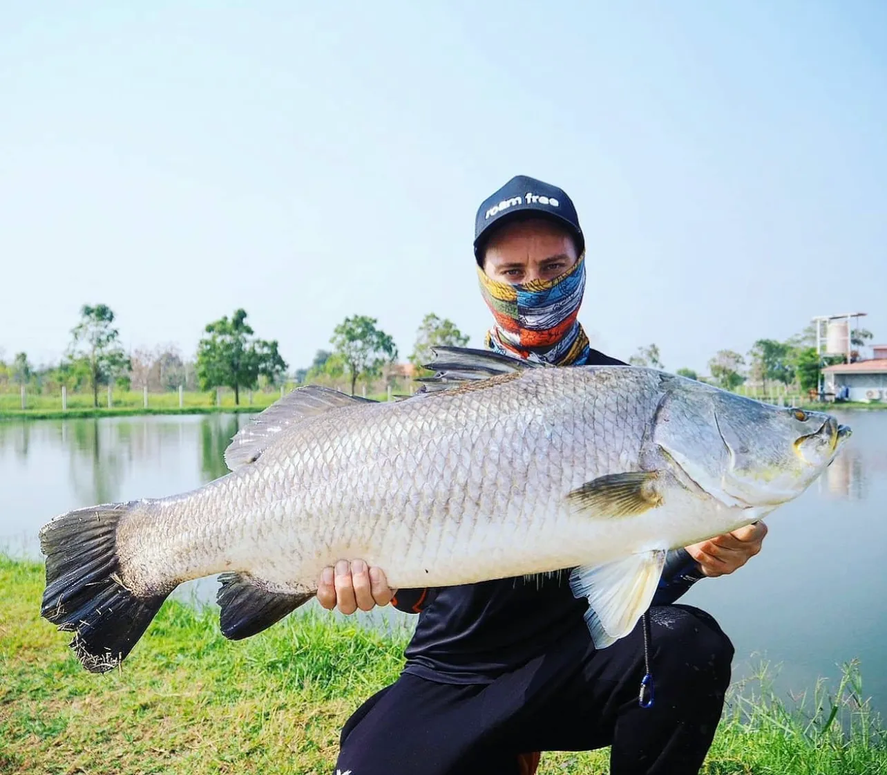 Angler holding a large barramundi caught at Pilot 111.