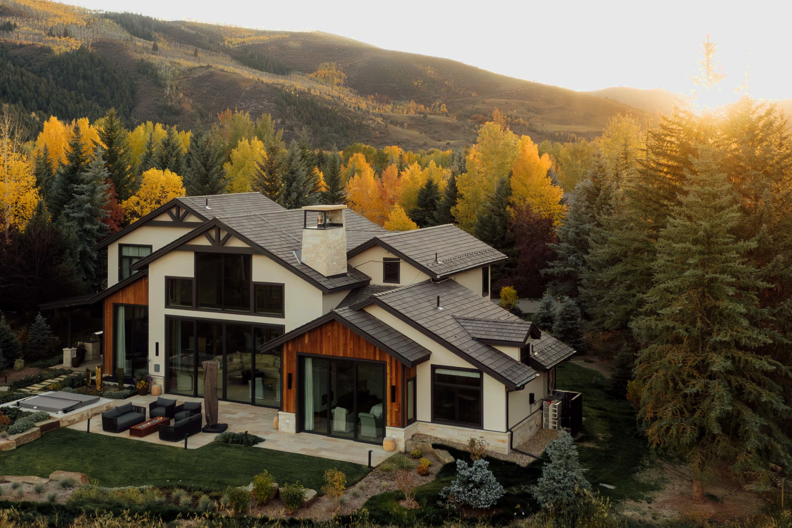 A Coleman Custom home among golden aspens at sunset