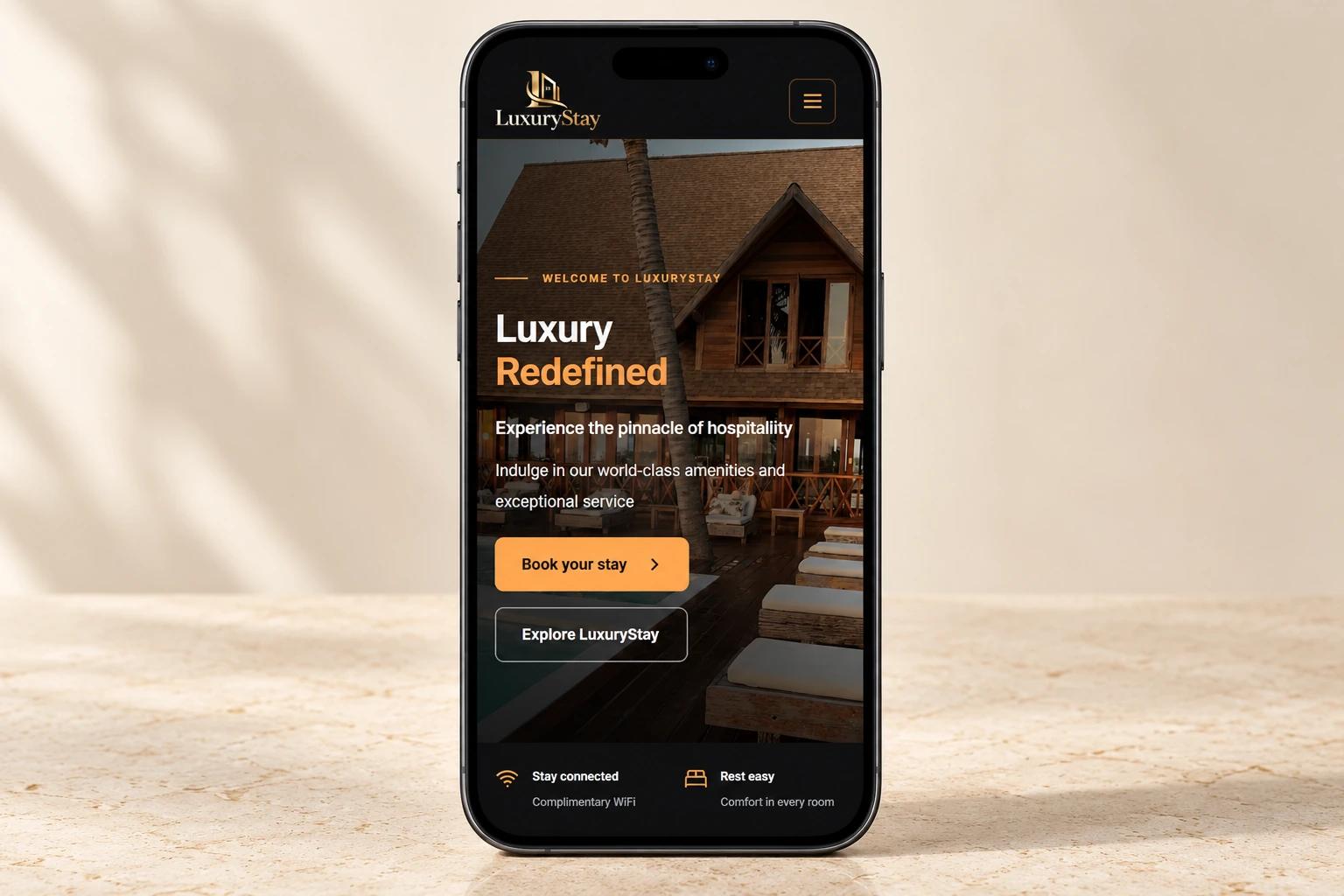 LuxuryStay responsive homepage displayed on a graphite smartphone