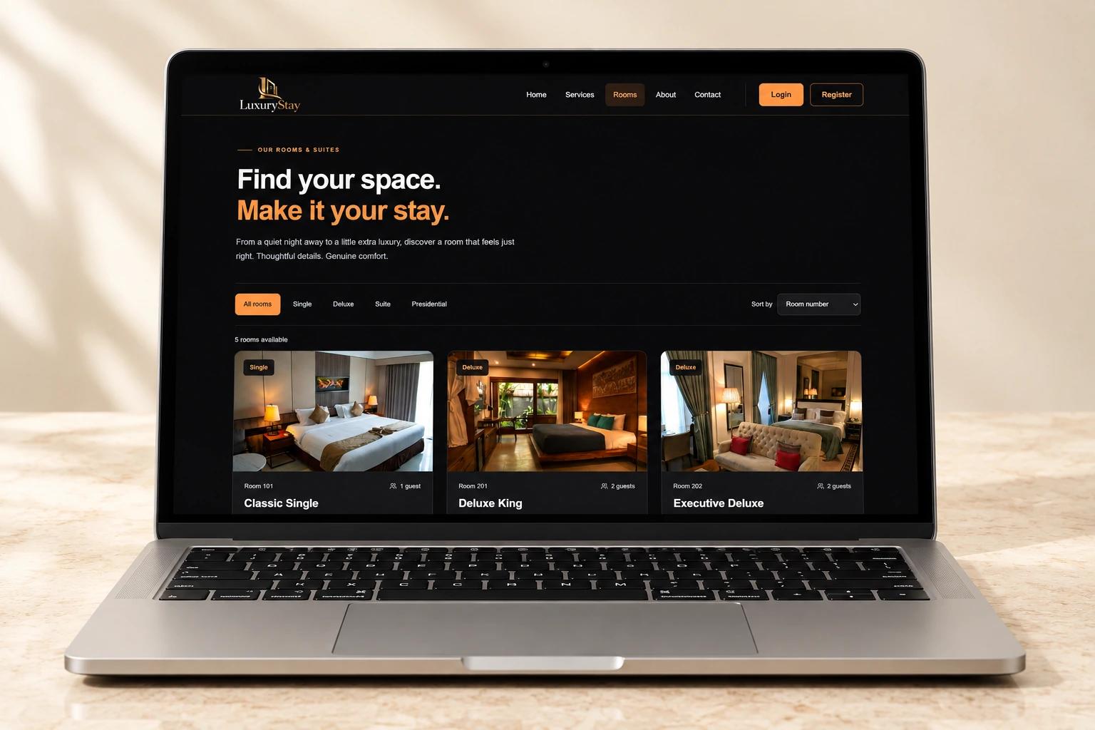 LuxuryStay room discovery page displayed on a silver laptop