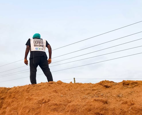 Fiifi about to run on higher grounds. The inscription on his vest says: Donate books