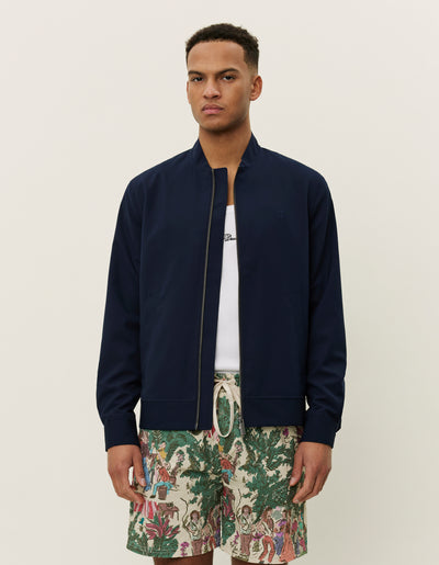 Bold Patterns: Floral Shirt Meets Solid Dark Bermudas