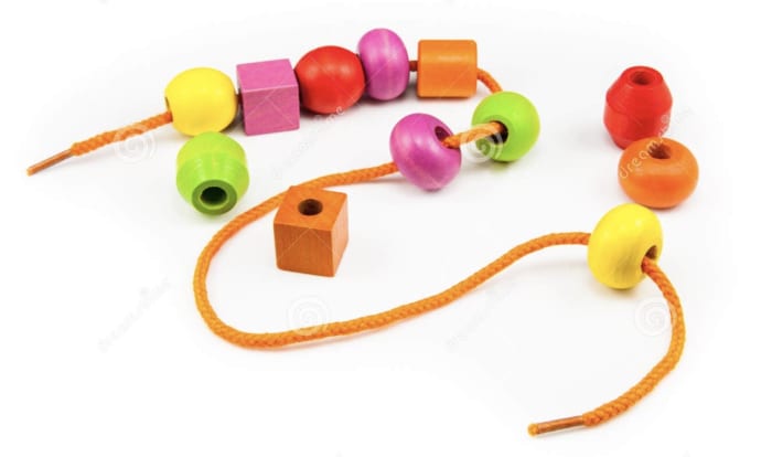 colorful beads being strung on an orange string